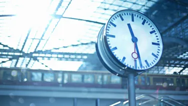 Sunny day over a clock at a railway station.