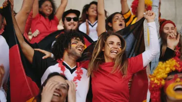 Young German fans in the stadium. German fans in the stadium cheer on the football championship.