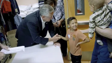 Brian Gallagher talks to a little boy in a closet