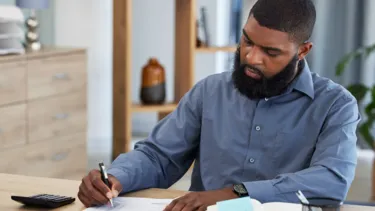 Young black student going through a checklist.