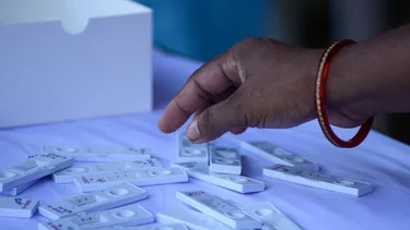 Female hand reaches for a corona test