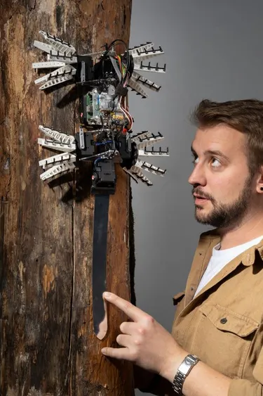 Dr. Robert Siddall with a robot modeled after a bird.