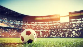 Football on grass in the stadium