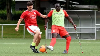 Footballer Setonji Ogunbiyi playing soccer with another player 