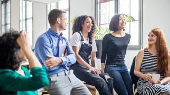 Colleagues laughing during a meeting