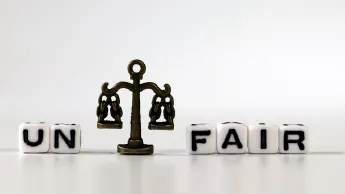 Scale and dices with the inscription "UN" and "FAIR" - symbols for justice