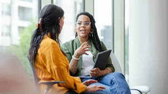 Two young women have a factual and constructive conversation.