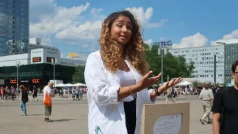 Female scientist presents her work in a public place.