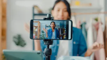 A woman is looking into a camera.