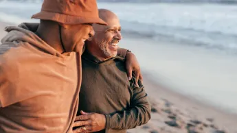 Two elderly men are happy on the beach