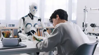 Young pupil learns together with a robot.