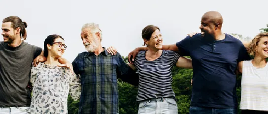  Several people are standing in a row with their arms around each other.